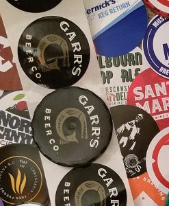 various custom printed keg cap stickers in a collage